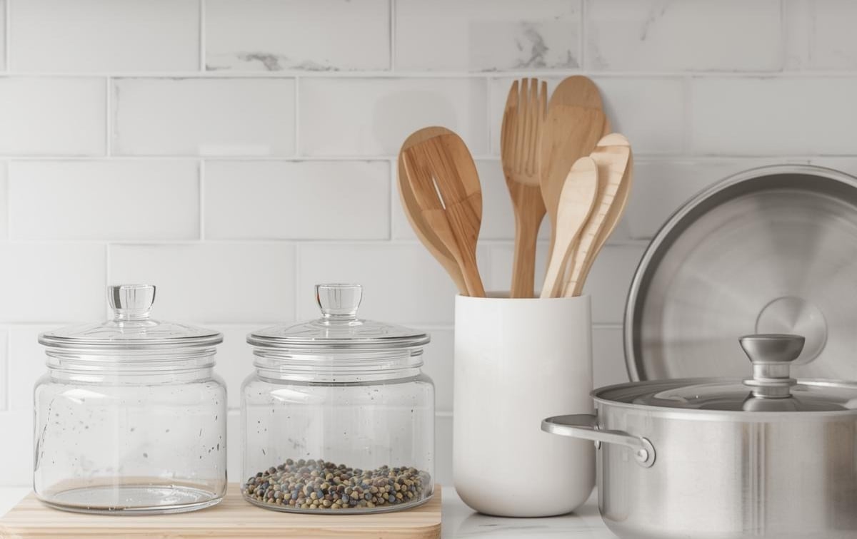 Non-toxic kitchen swaps for 2026 — stainless steel cookware and wooden cutting board on a clean kitchen counter