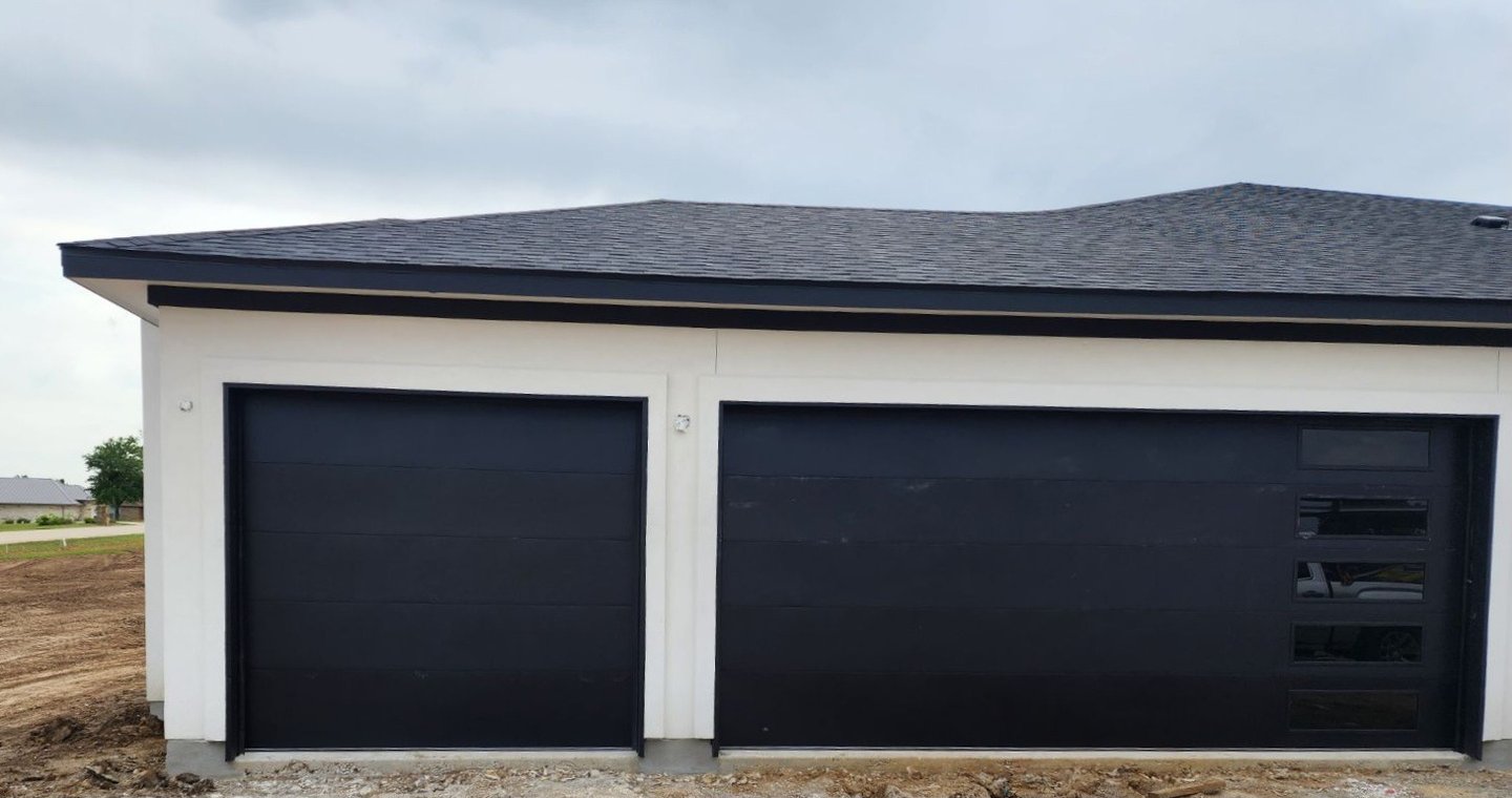 1 8x8 flush black garage door and 1 16x8 black flush with windows on the right hand side garage door