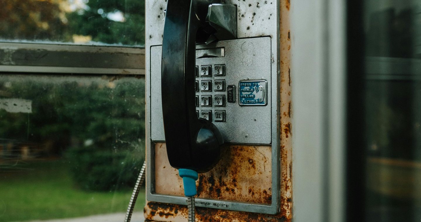 a phone booth with a phone and a telephone booth