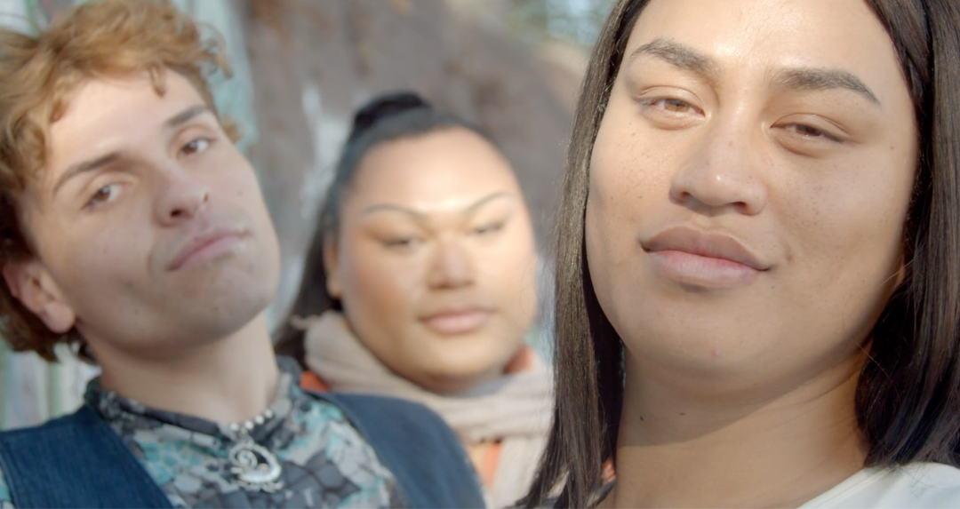 Three people gazing or smiling into the camera.