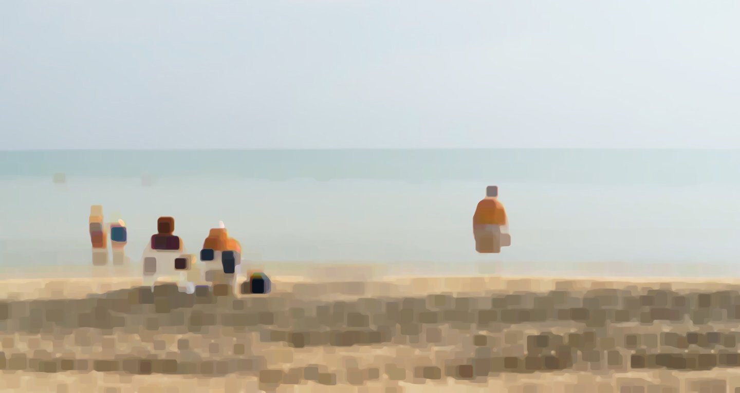a group of people sitting on a beach
