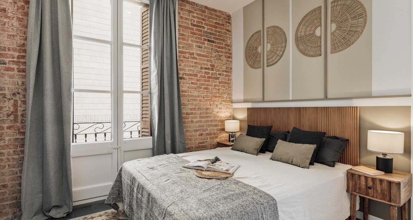 Relaxing bedroom with natural wood finishes, neutral tones, and minimalist design in Barcelona