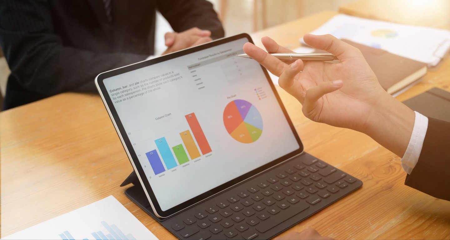 Analyzing business charts on a tablet to lead smart, prioritize, and optimize.