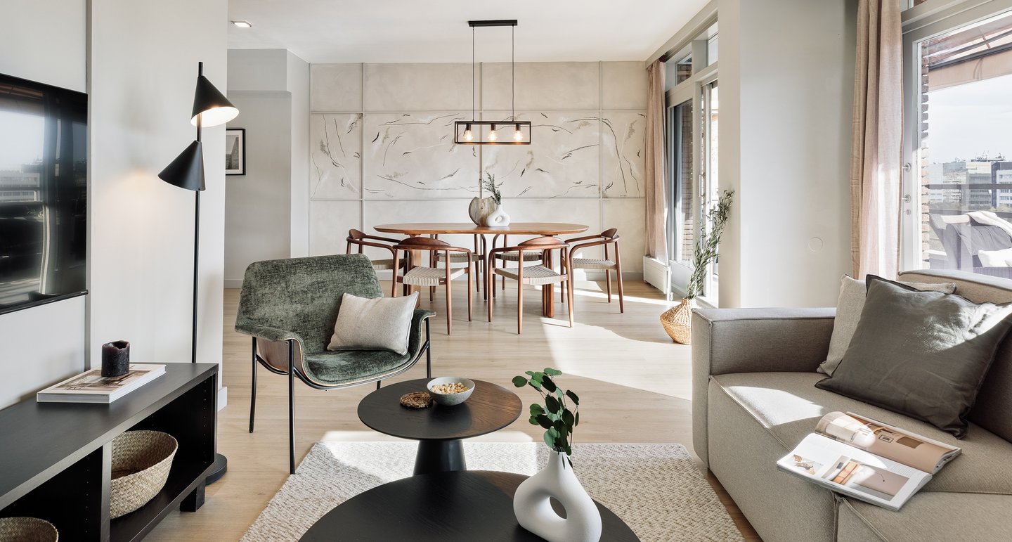 Elegant living room with contemporary furniture, custom art, and neutral tones designed by SAVIA