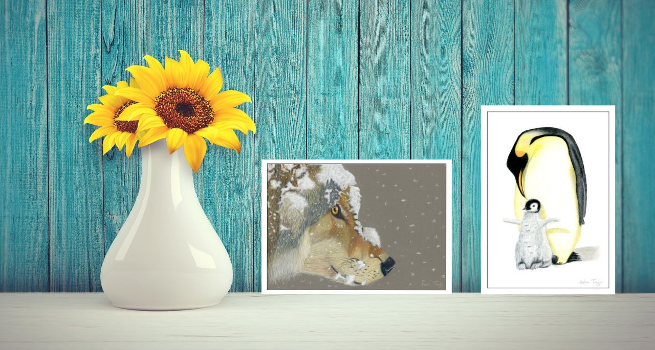 Wolf and penguin greeting cards on a shelf next to yellow sunflowers in a white vase.