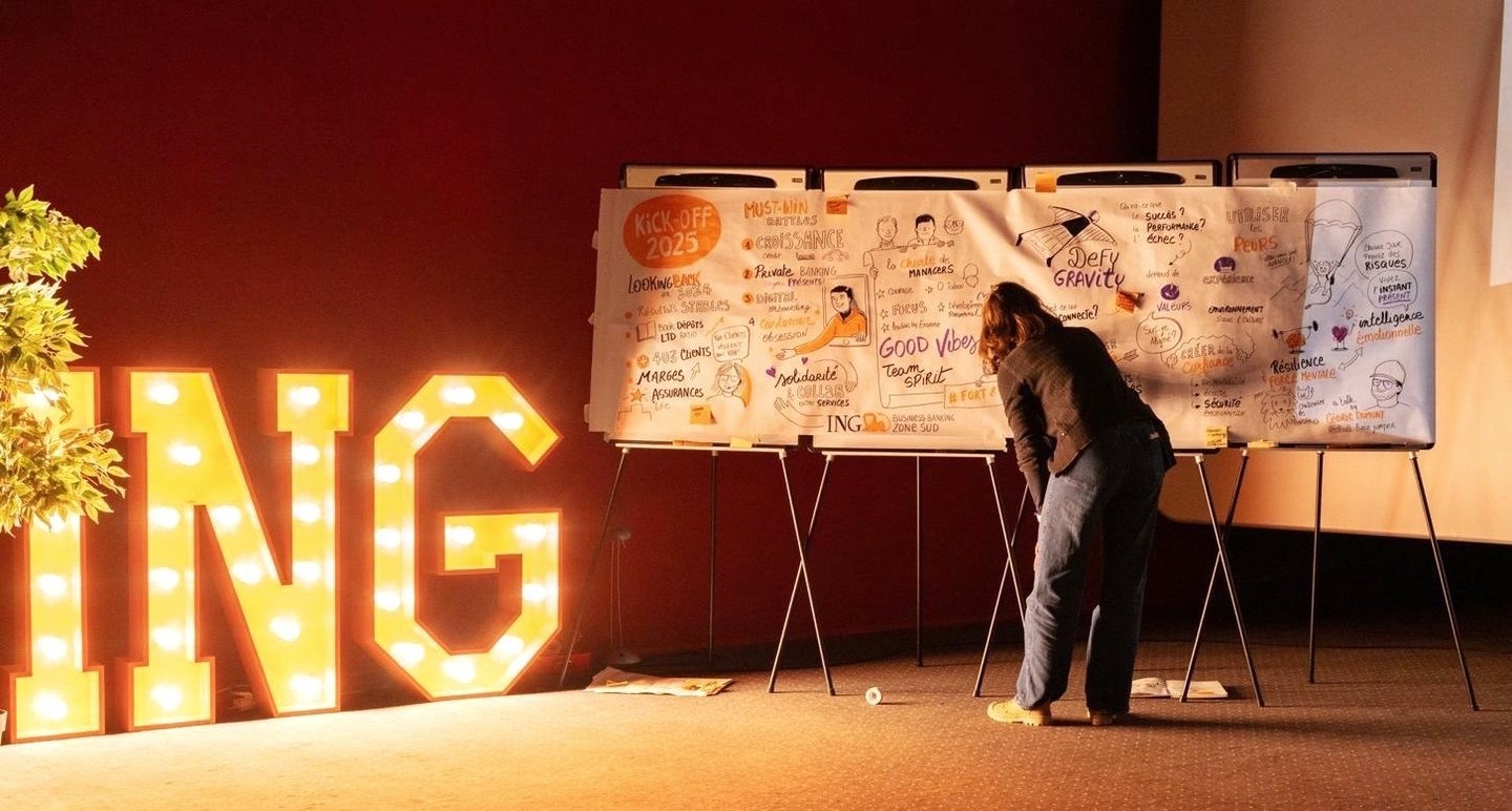a woman drawing on a white board