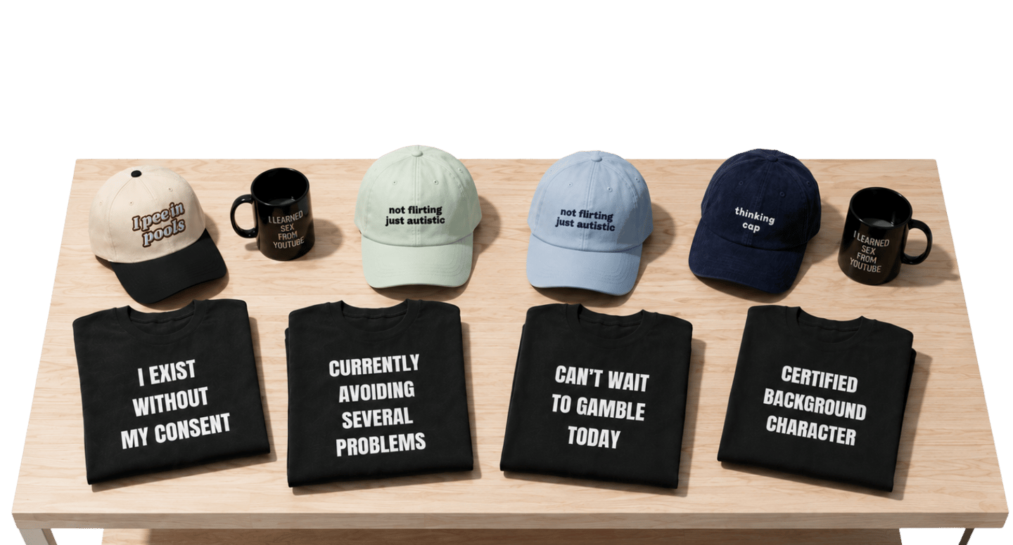 Collection of novelty graphic t-shirts, embroidered baseball caps, and mugs with funny slogans on a wooden table.