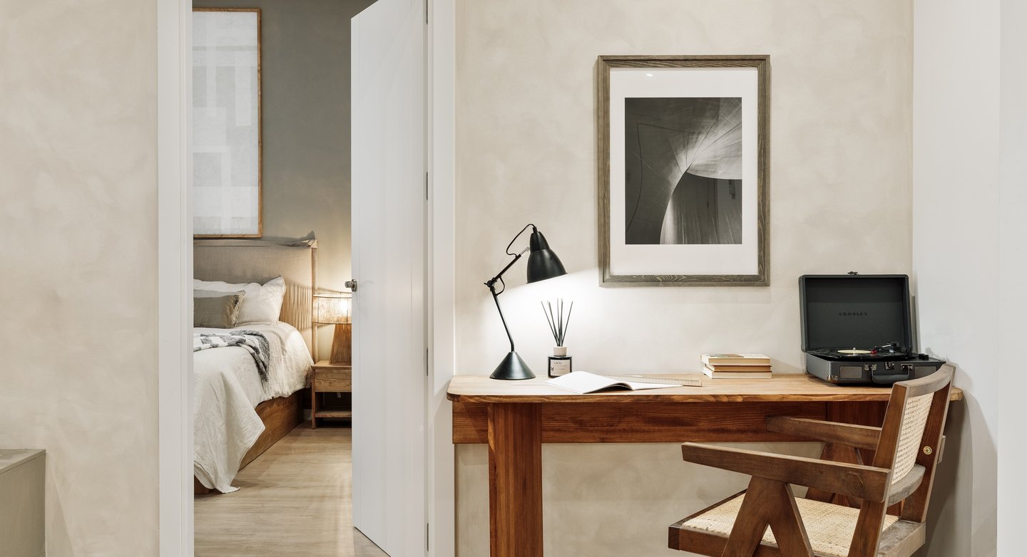 Elegant bedroom with custom artwork and brown and beige colour palette in Barcelona