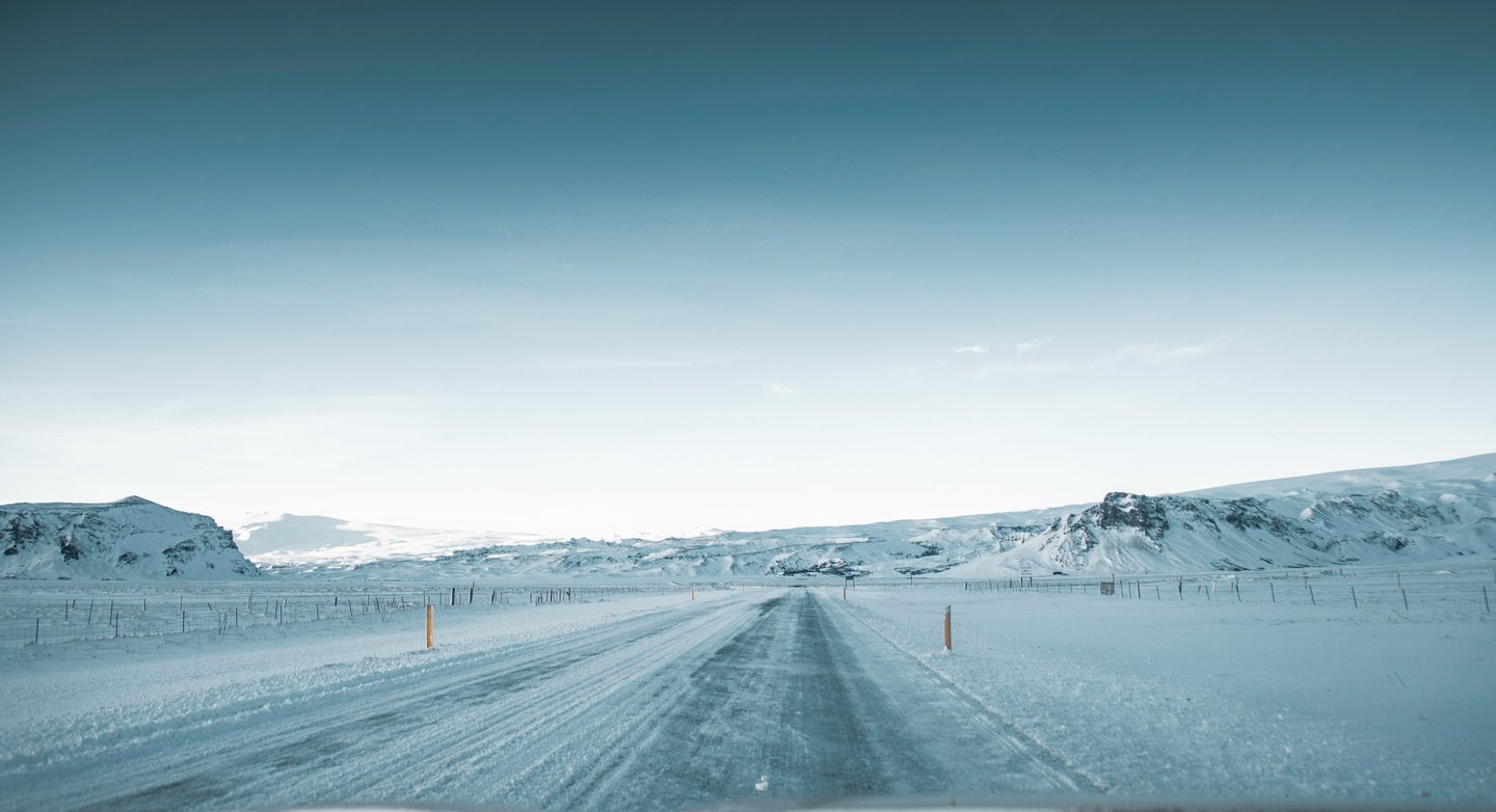 a car driving down a snowy road