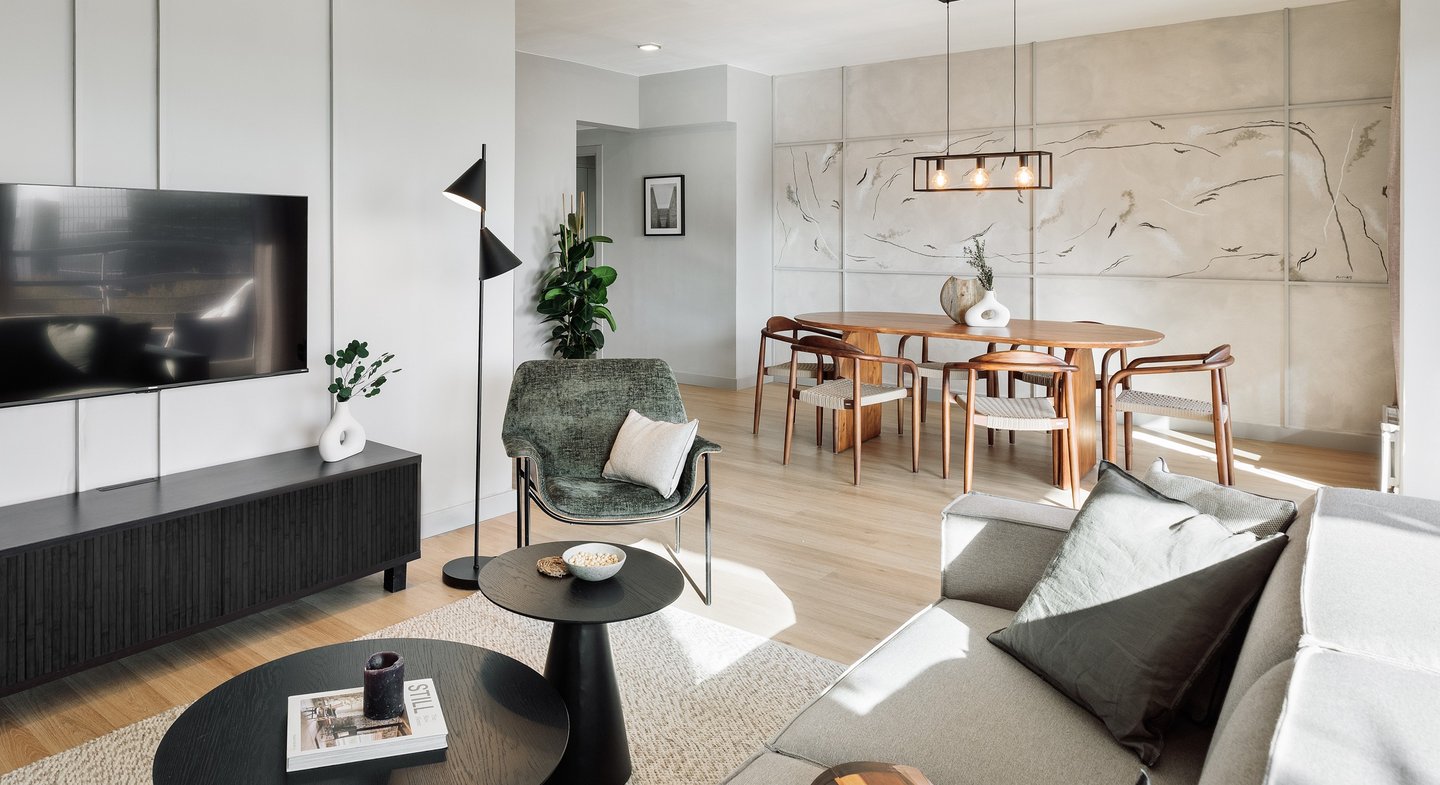 Modern dining area with metal light fixture, wooden dining table, and minimalist interior design