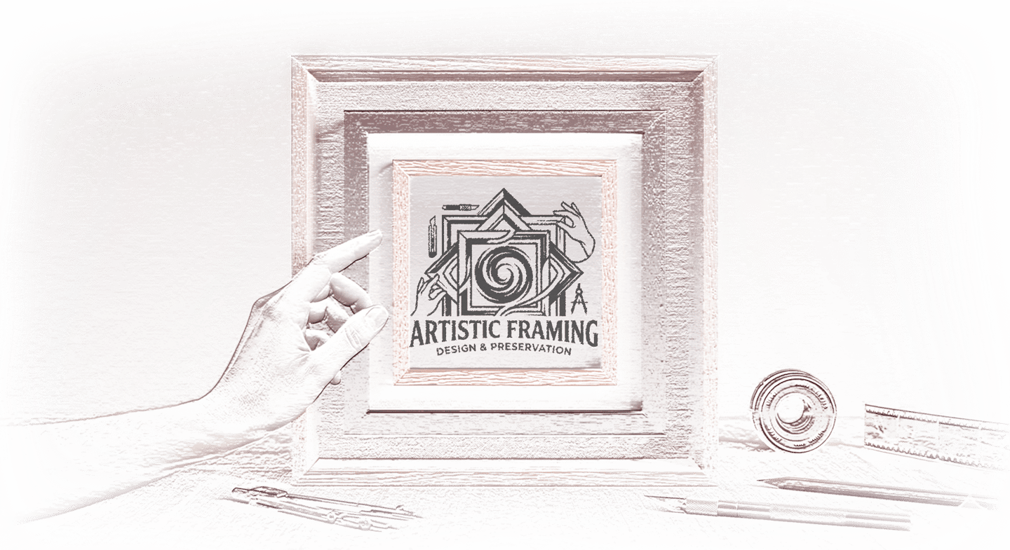 Custom wooden frame displaying the Artistic Framing Design & Preservation logo with drafting tools.