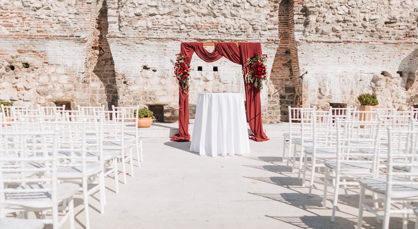 a wedding ceremony with a red drapeed up wedding ceremony