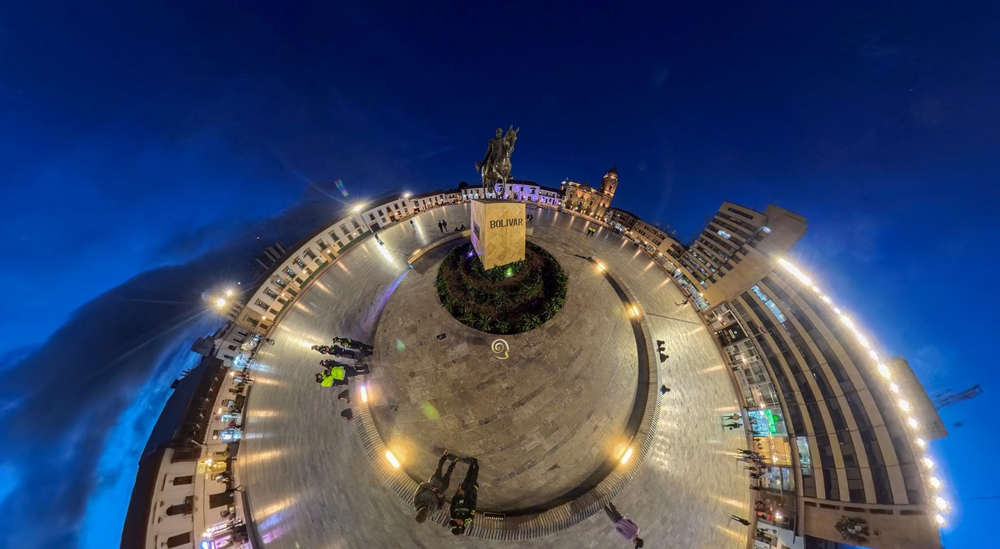 Panoramic 360 view of Plaza de Bolivar in Tunja, Colombia at night with the equestrian statue.