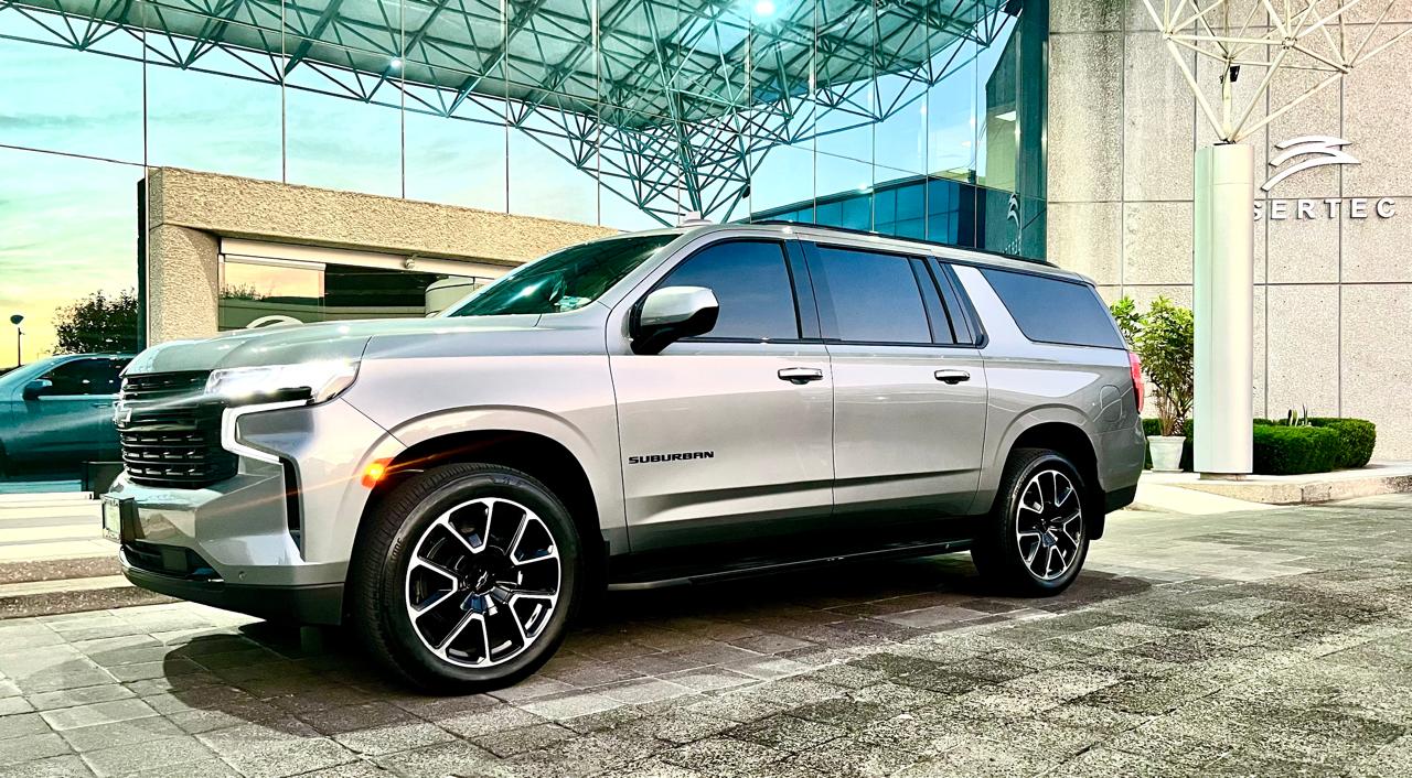 a silver suv parked in front of a building