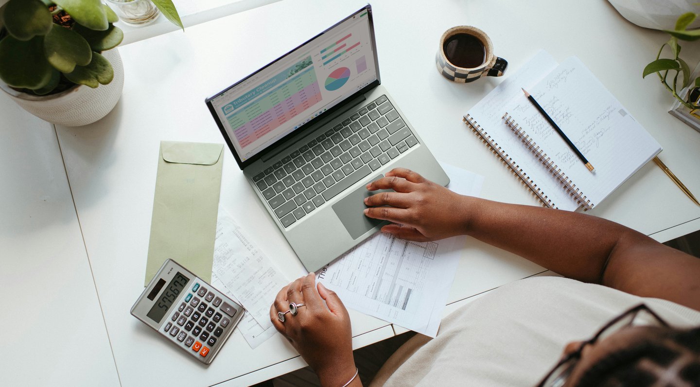 A person sitting at a table with a laptop