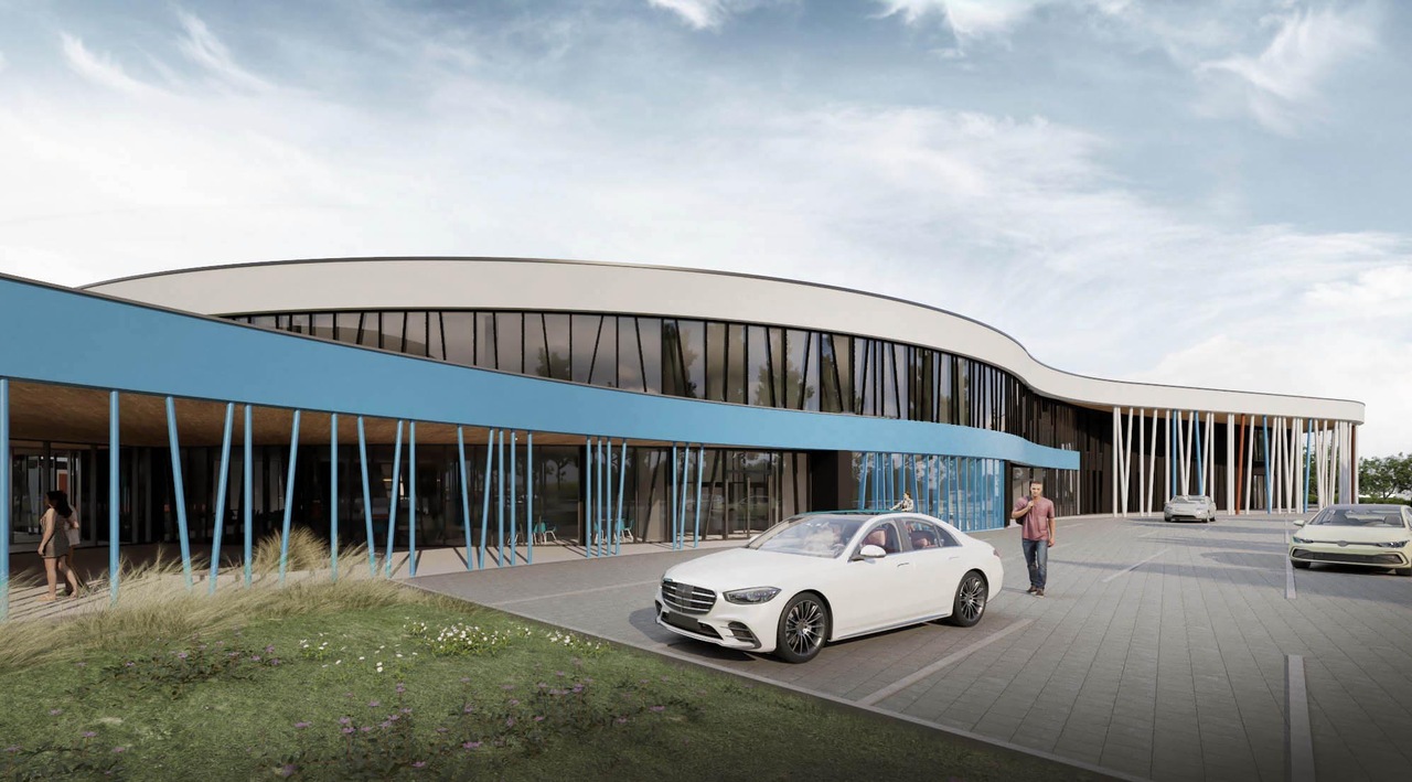 nowoczesna elewacja budynku centrum sportowego z turkusowymi elementami i szklaną ścianą kurtynową