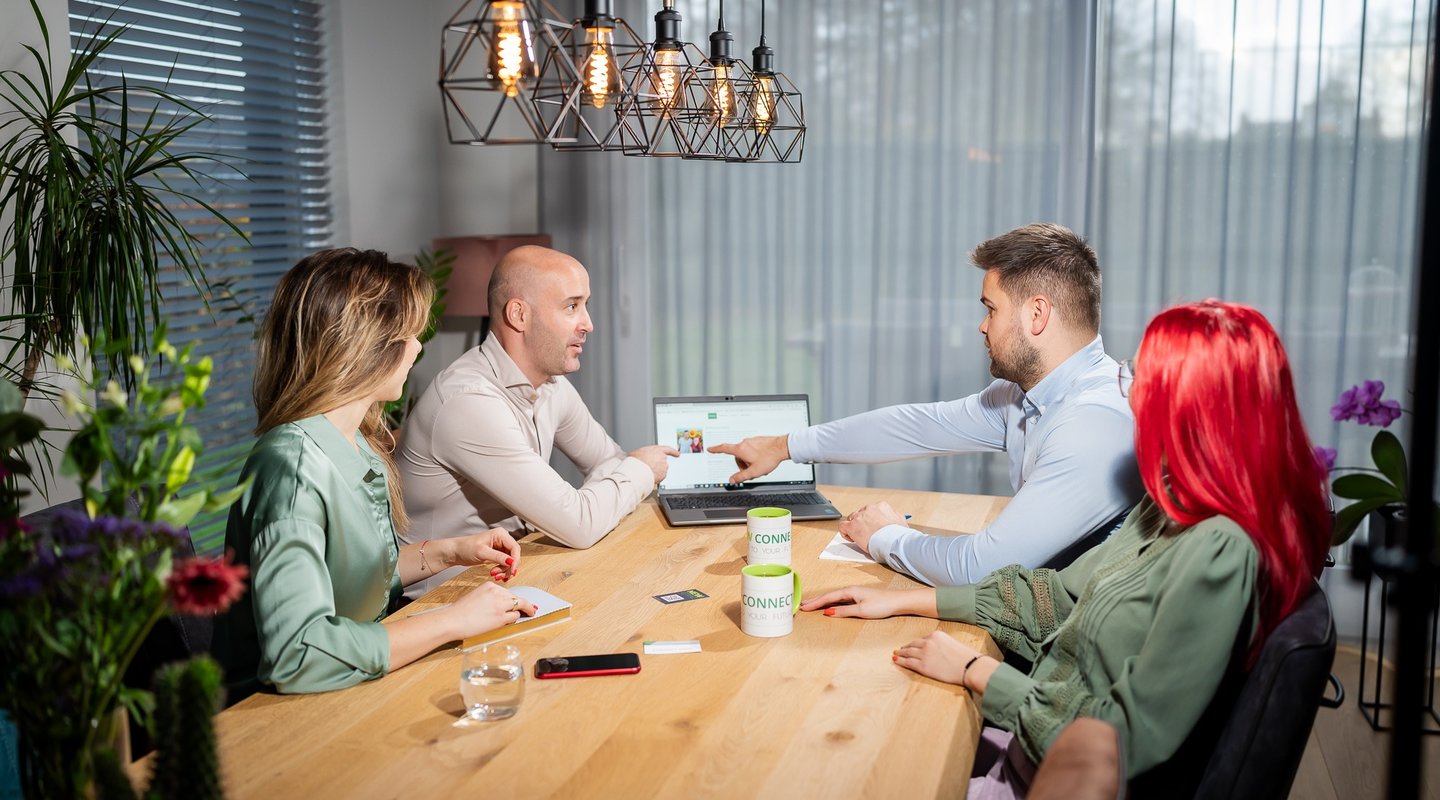 a group of people sitting around a table
