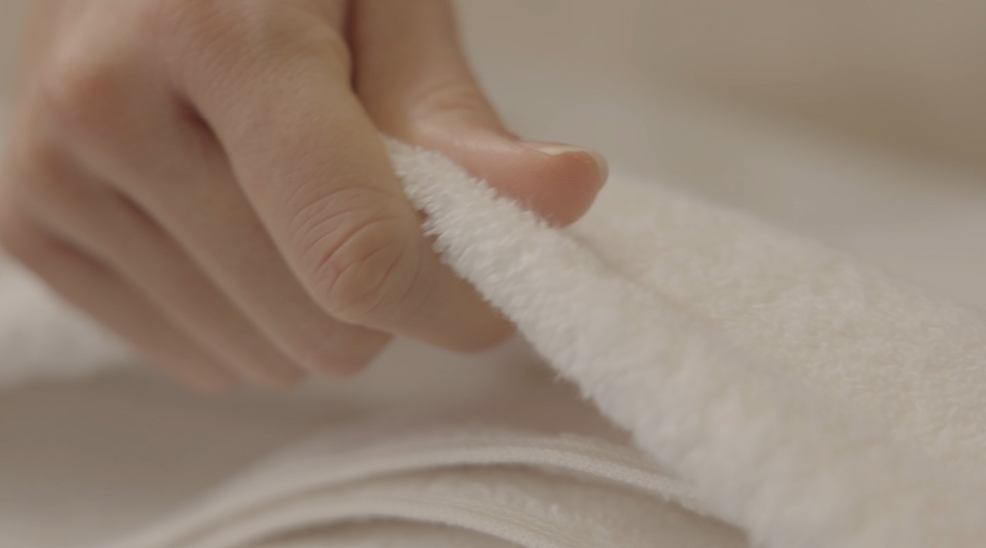 a person holding a towel over a towel
