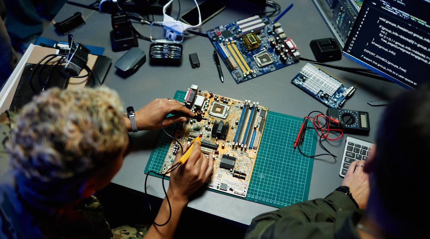 Electronics prototyping and board testing at a workbench.