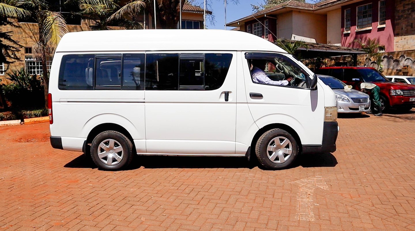 White passenger van shuttle for car hire and transportation services - Vanna Ventures