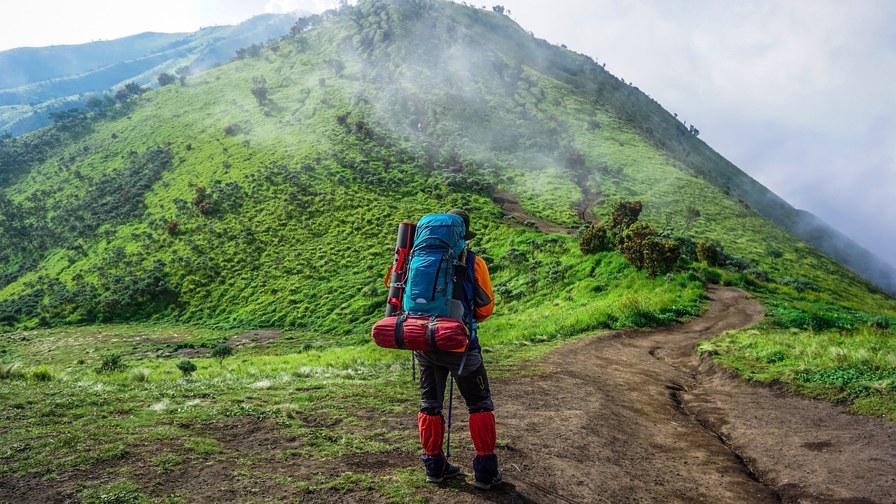 a man with a backpack on a mountain