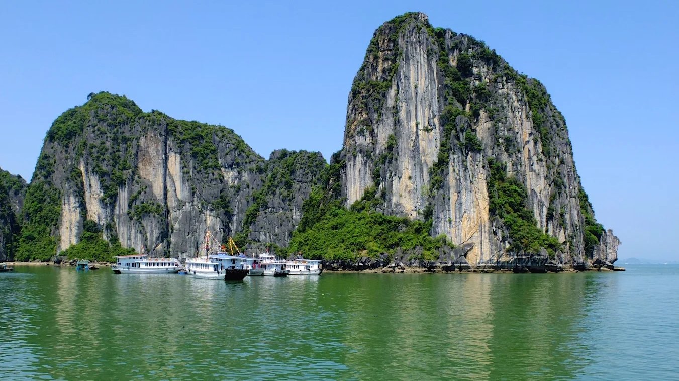 a group of boats floating on top of a body of water