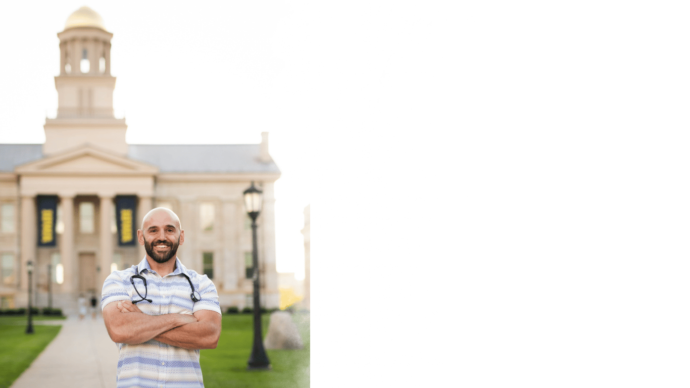 Peter Rosen, FNP with Connected Care NP standing in front of the Old Capitol building in Iowa City
