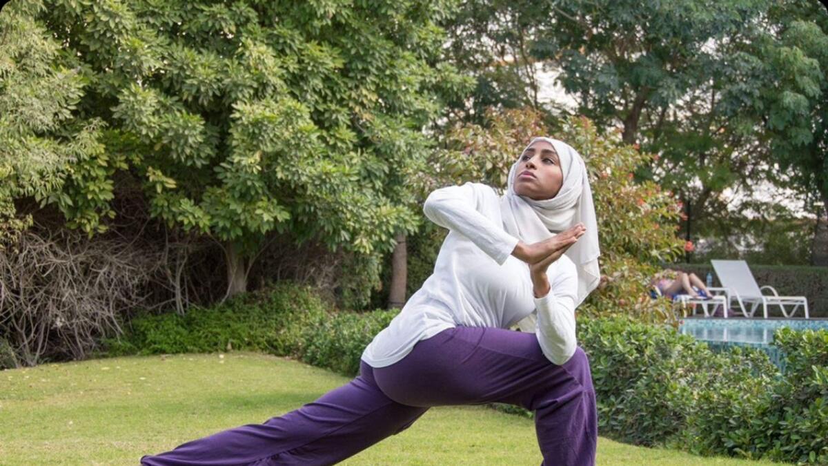 Woman in hijab practicing yoga in dubai