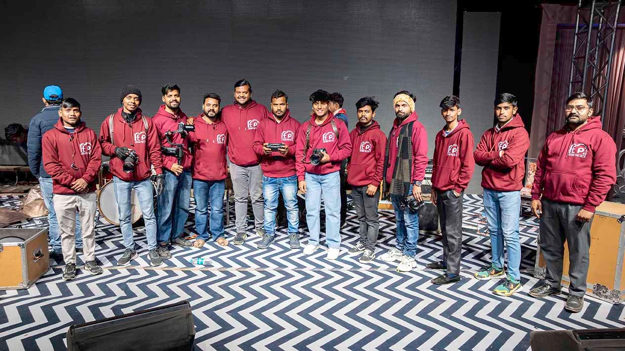Elegant Photo Studio team of photographers and videographers in matching branded hoodies