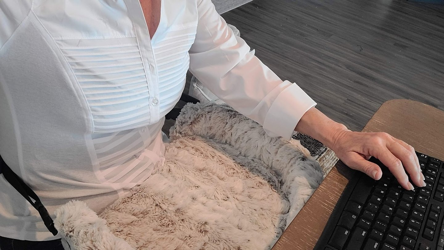 Lady at computer with Furr Lap Pet Bed in her lap 