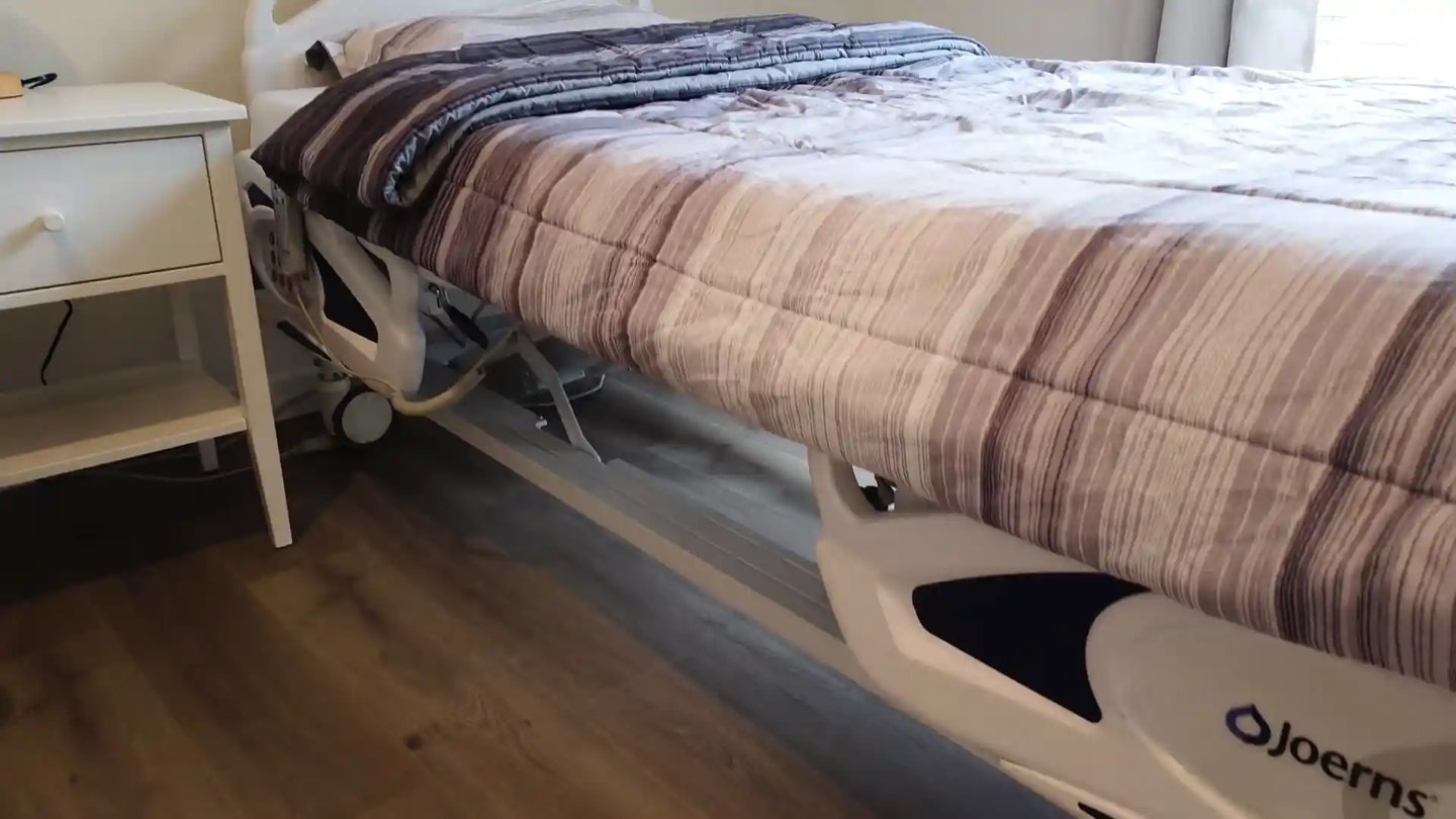 Adjustable medical bed in a comfortable AFH room, supporting safe rest, mobility, and daily care for residents.