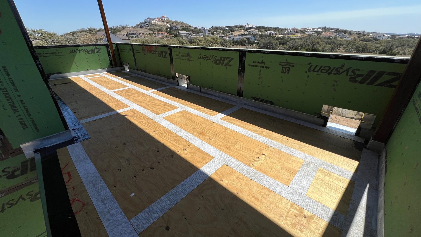 Waterproofing plywood joints before apply membrane and concrete on custom home balcony.