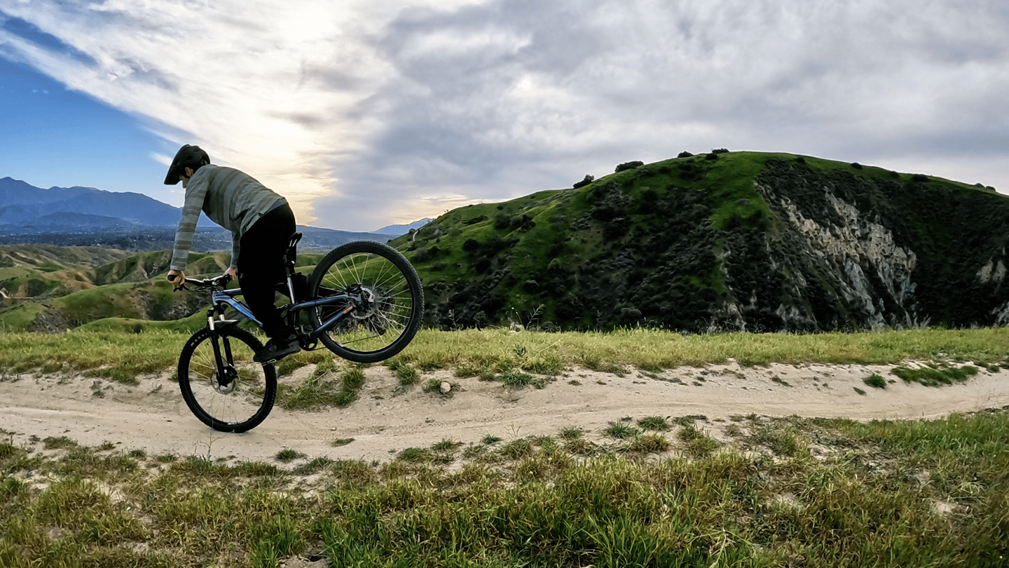Mountain biker about to set the rear wheel down after a stoppie