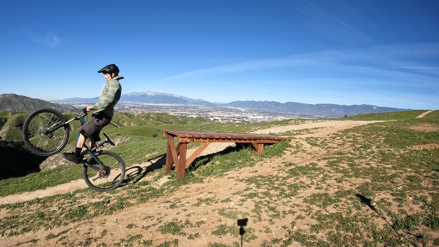mountain biker going off drop