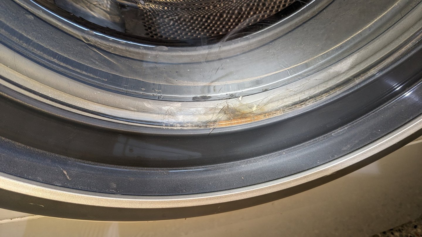 Front load washer door with stuck hair