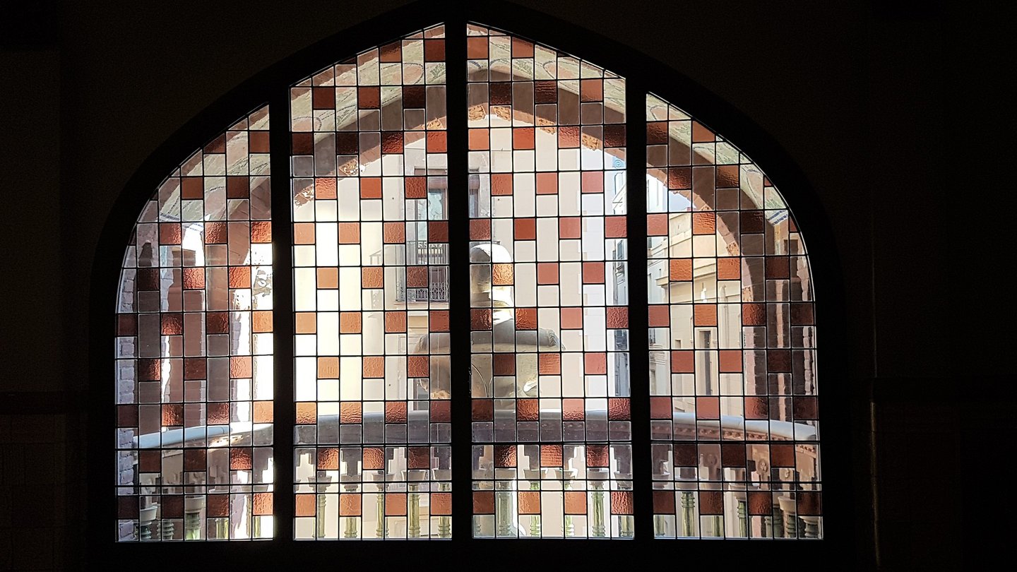 a window with a clock and a clock tower