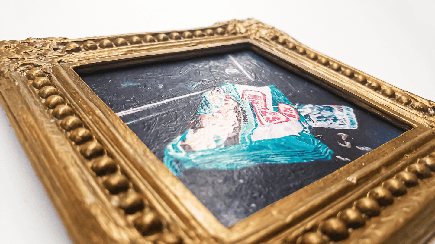 a close-up photo of a miniature painting magnet in a gold gilded frame
