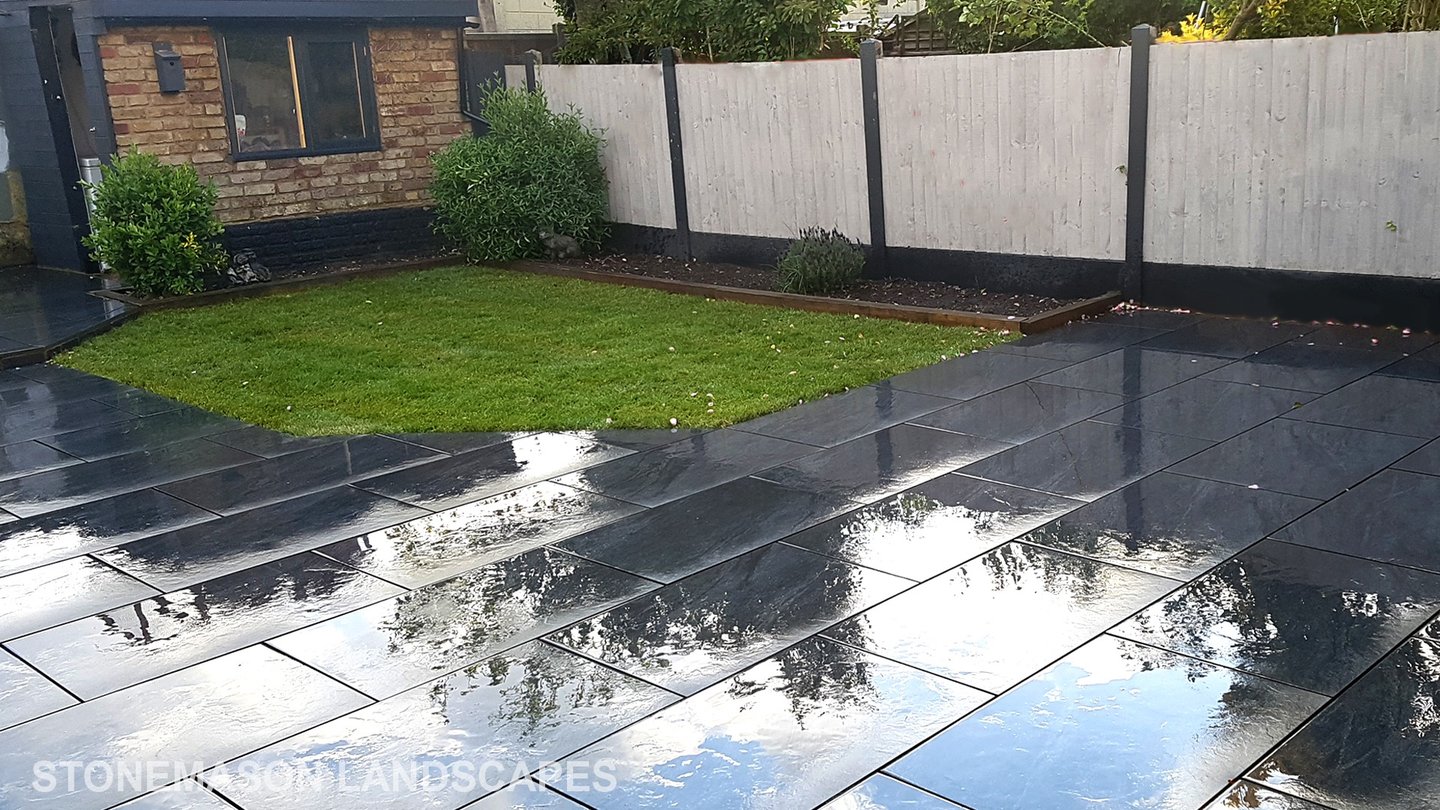 Grey sandstone circle paving slabs with charcoal edging
