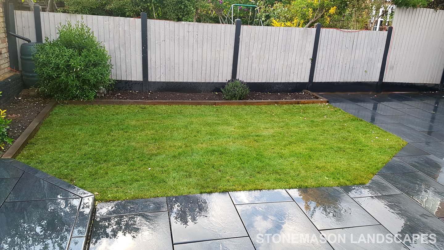 Grey sandstone circle paving slabs with charcoal edging