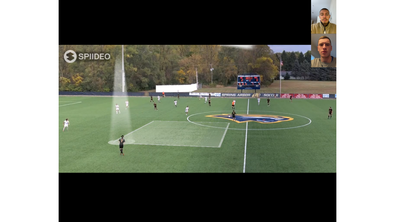 Coach Loic Baures doing film review with a youth athlete