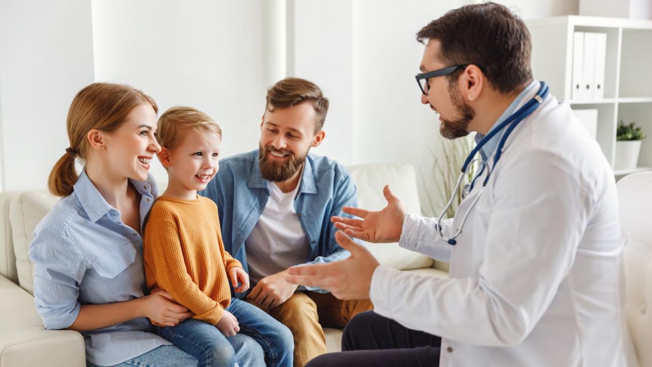 a doctor talking to a child in a living room martin pe / coach