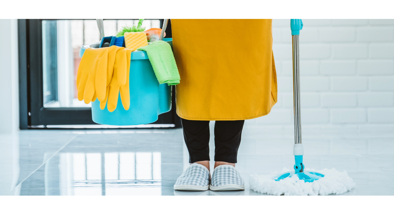 a woman in a yellow dress holding a mop and cleaning supplies