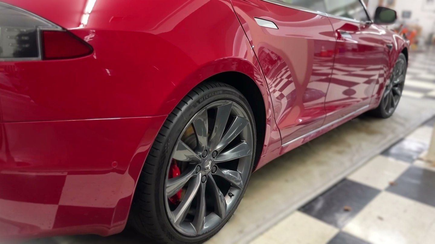 ceramic coating of red tesla in detailing garage