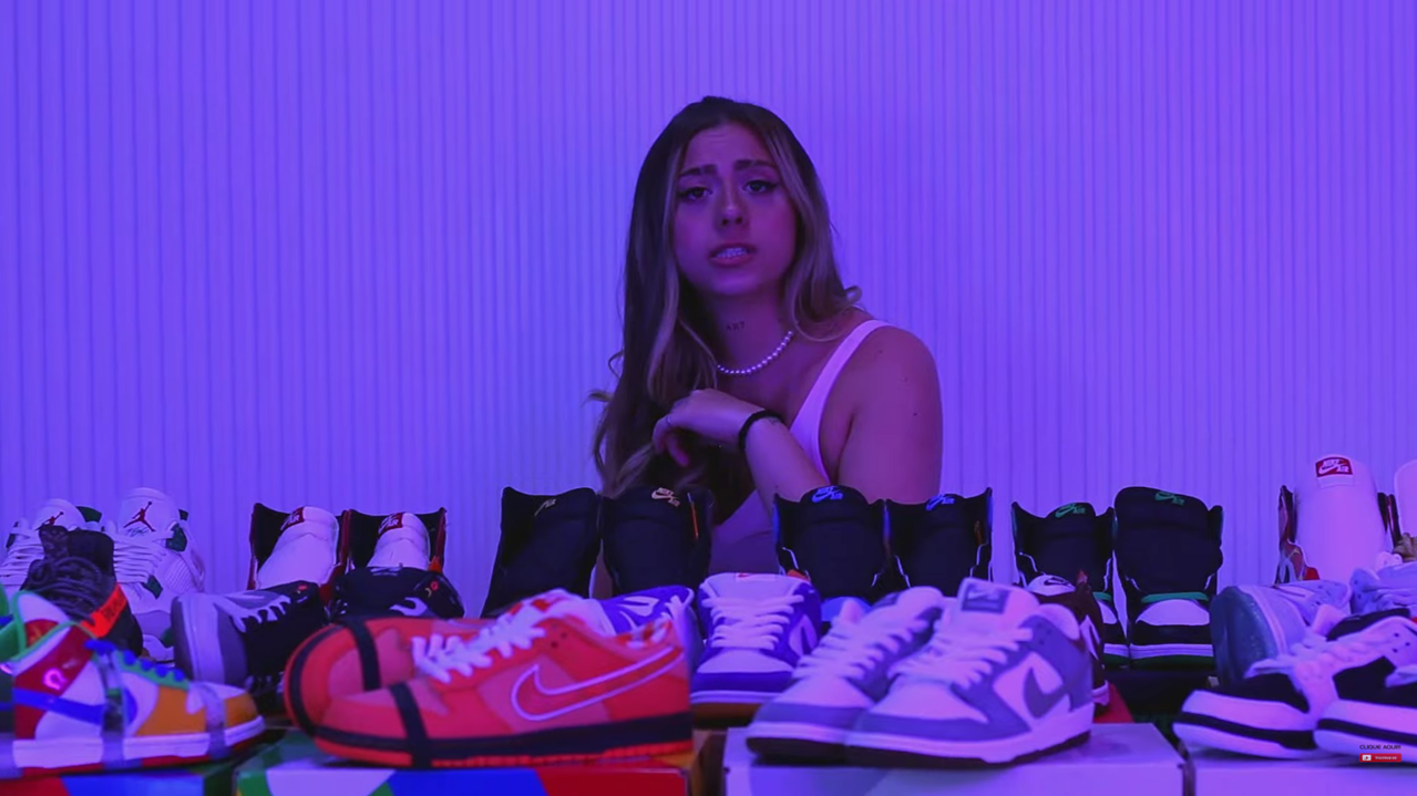 a woman standing in front of a table with a lot of shoes