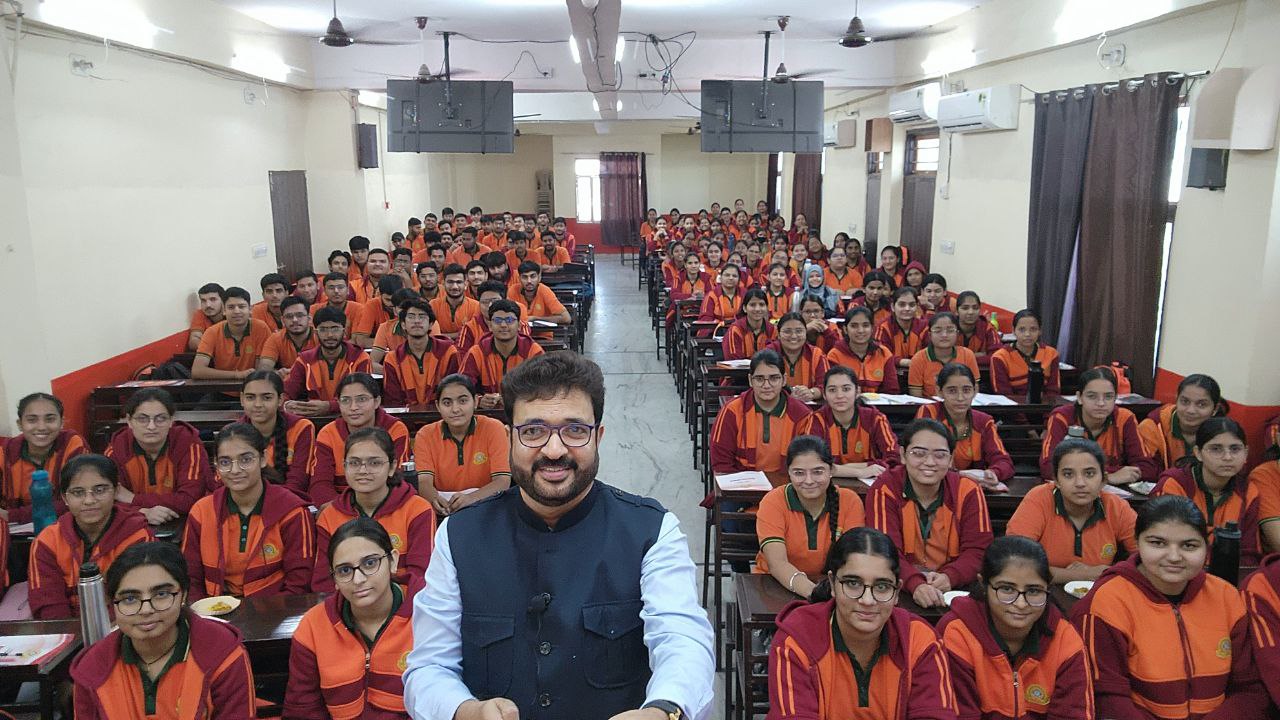 Mentor with a large group of students in a classroom setting.