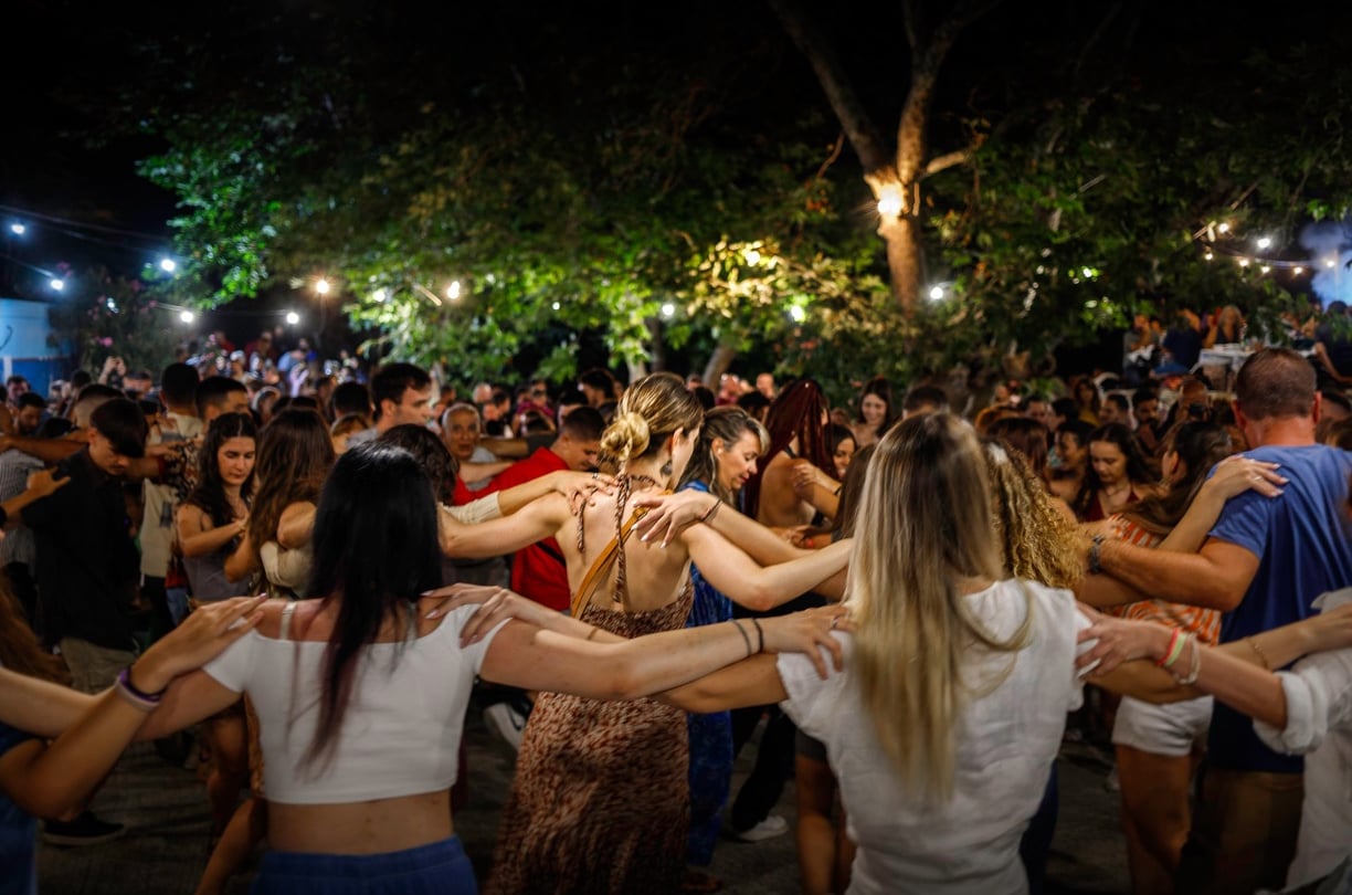 a group of people dancing in a circle