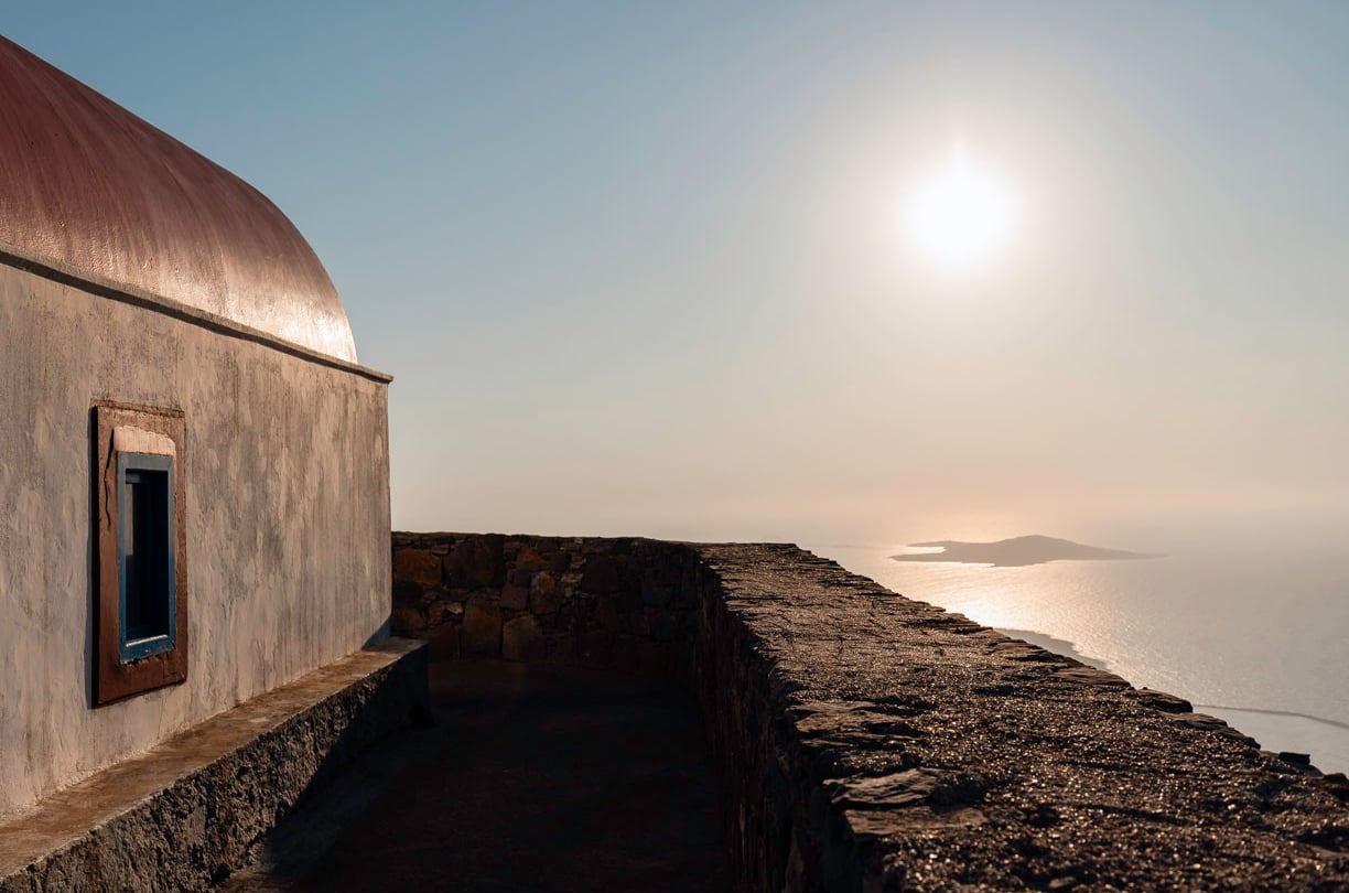 a building with a window and a window with a view of the ocean