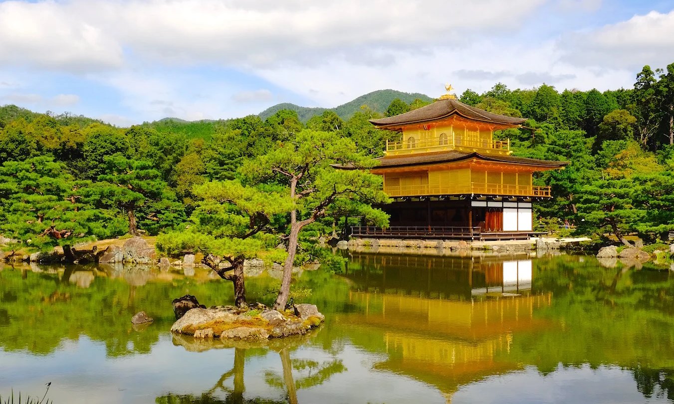 a golden temple in the middle of a lake