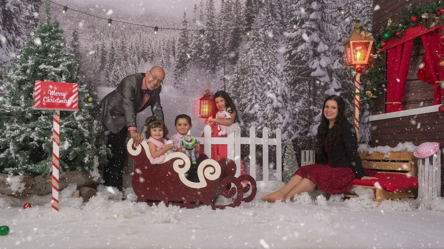 a family posing for a photo in a snowy scene
