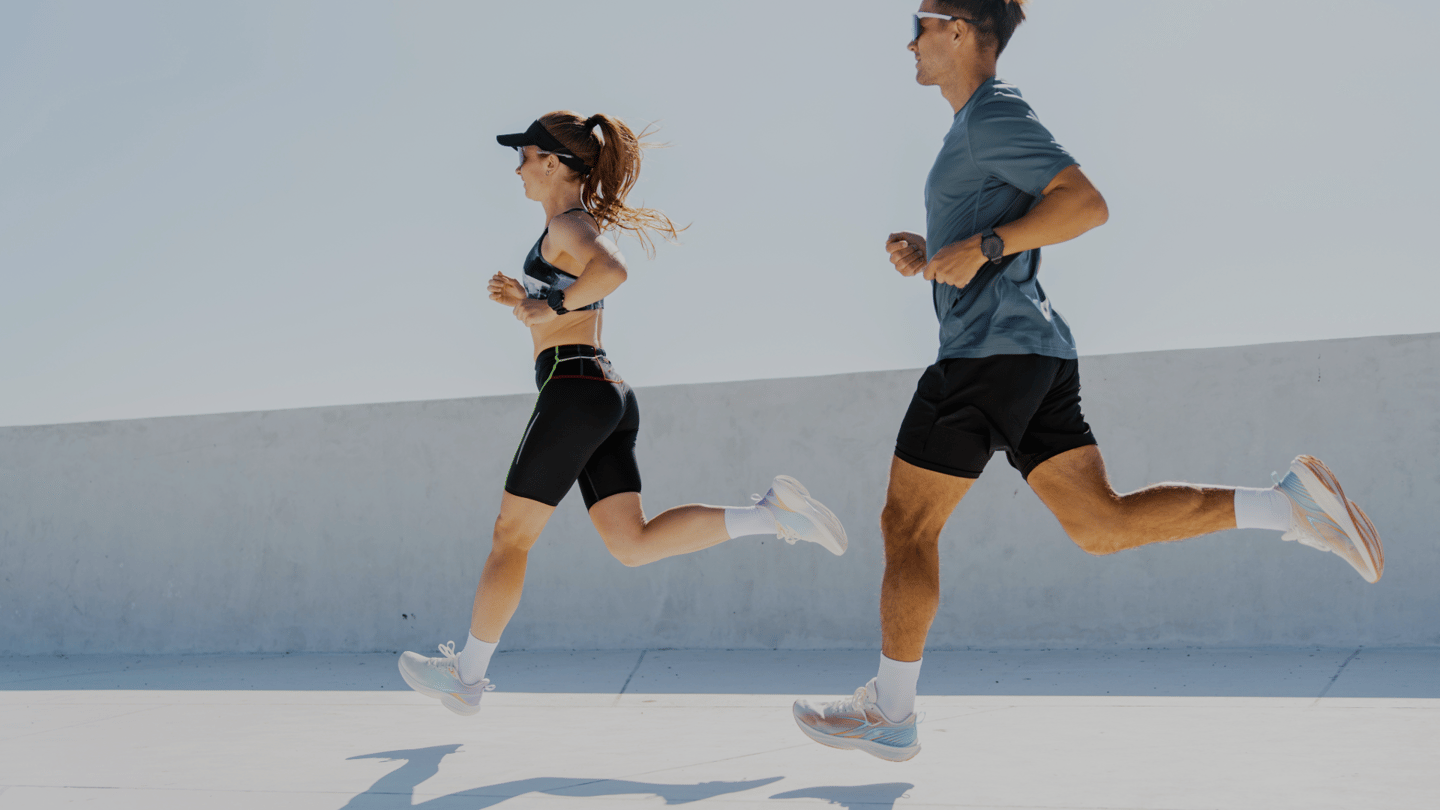 a man and woman running in a city